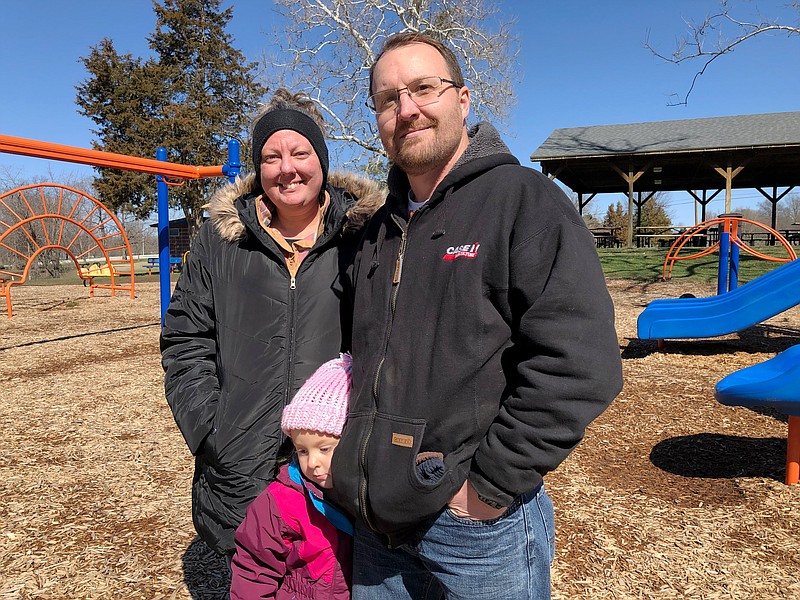 Jacob Gayler, his wife, Mandy, and their daughter, Hattie, enjoy the nice weather Friday morning at Veterans Parks in Fulton.