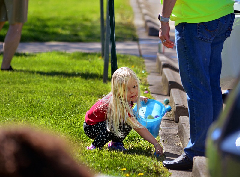 Sally Ince/ News Tribune
Fiona Brockmeyer, 4, finds and egg Saturday April 20, 2019 during the annual Children’s Community Easter Egg Hunt at Wesley United Methodist Church. The hunt was divided into three different age groups and areas to allow children to find eggs more safely. Families were also invited to paricipate in making Easter themed crafs and getting their faces painting during the event.