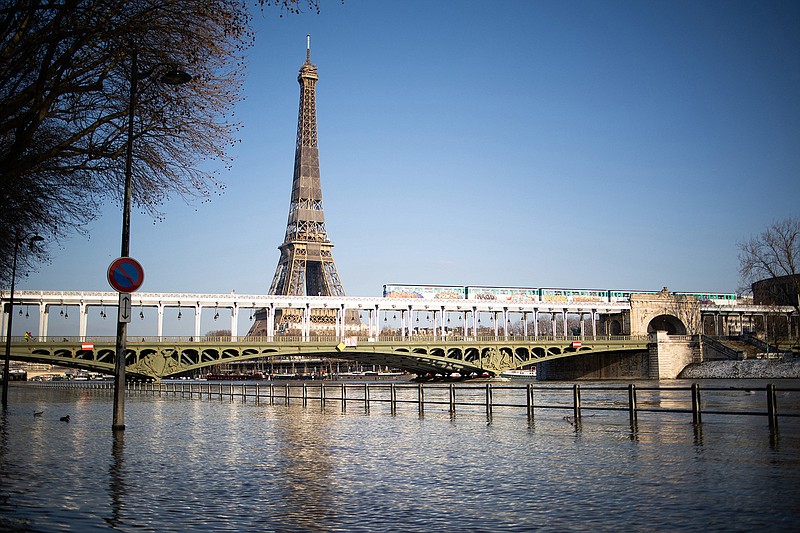 It could be a while before Americans get to take in this view of the Seine with the Eiffel Tower in person. (Raphael Lafargue/Abaca Press/TNS)