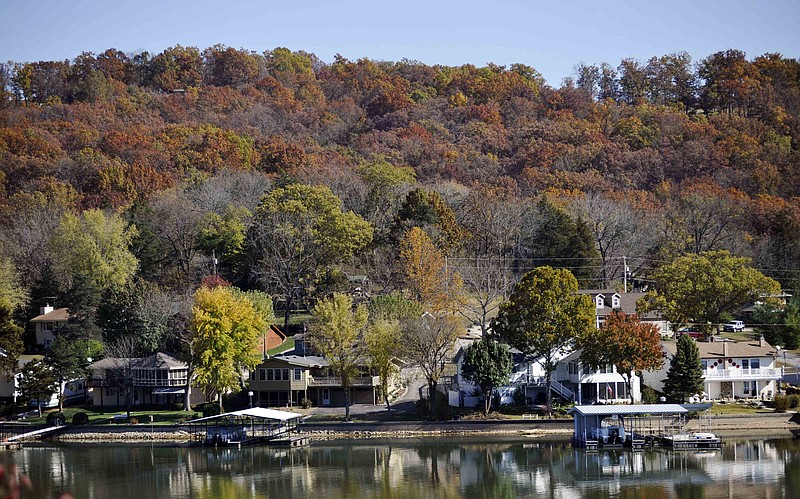 FILE - This Oct. 31, 2011, file photo shows lakefront homes at the Lake of the Ozarks near Camdenton, Mo. Missouri's Republican delegation in Congress is asking the Environmental Protection Agency to reconsider listing 40 Missouri lakes and waterways on a list of impaired waters. (AP Photo/Kelley McCall, File)