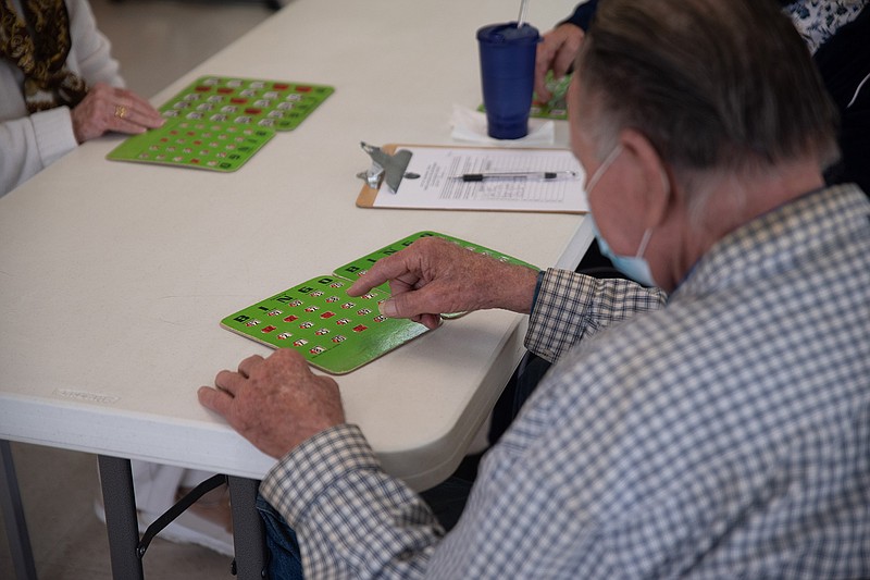 Seniors play bingo at the Collins Senior Center on Thursday afternoon. The Center has opened to the public after being closed for almost a year.