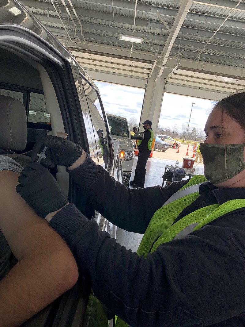 <p>Ryan Boland/FULTON SUN</p><p>Jill Griebel, a paramedic with the Callaway County Ambulance District, administers the Pfizer COVID-19 vaccine to an individual during Friday’s mass vaccination event at Callaway Electric Cooperative in Fulton. Approximately 2,200 doses of the vaccine were available for the eight-hour, drive-through event, which was supervised by the Missouri National Guard and the State Emergency Management Agency.</p>