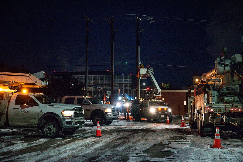 In this Feb. 18, 2021, file photo, an Oncor Electric Delivery lineman crew works on repairing a utility pole that was damaged by the winter storm that passed through Odessa, Texas. Texas officials on Thursday, March, 25, 2021 raised the death toll from February's winter storm and blackouts to at least 111 people — nearly doubling the state's initial tally following one of the worst power outages in U.S. history.. (Eli Hartman/Odessa American via AP, File)