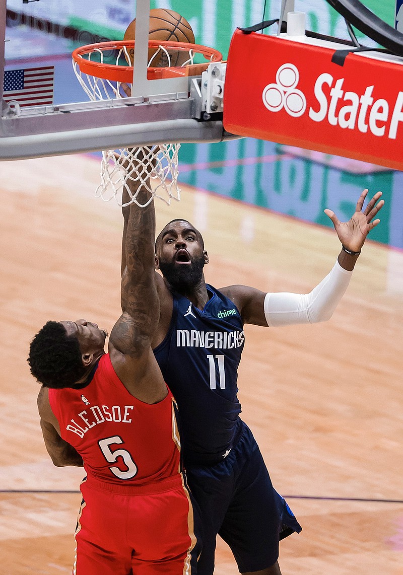 Dallas Mavericks forward Tim Hardaway Jr. (11) shoots over New Orleans Pelicans guard Eric Bledsoe (5) in the second quarter of an NBA basketball game in New Orleans, Saturday, March 27, 2021. (AP Photo/Derick Hingle)