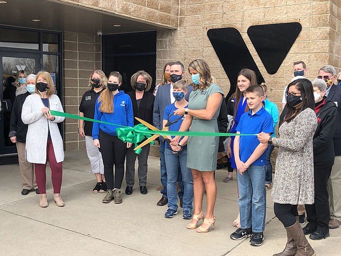 YMCA of Callaway County Chief Executive Officer Sara McDaniel cuts the ribbon during the organization's open house Friday morning to give the community a glimpse of the facility's expansion and renovation.