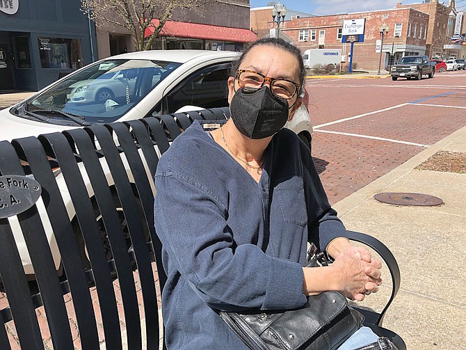 Janice Stone takes in some sunshine Friday afternoon while sitting on a bench along Court Street in downtown Fulton.