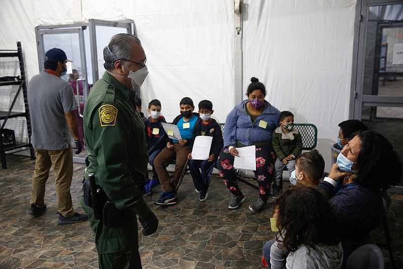 Migrants are processed at the intake area of the U.S. Customs and Border Protection facility, the main detention center for unaccompanied children in the Rio Grande Valley, in Donna, Texas, Tuesday, March 30, 2021.  (AP Photo/Dario Lopez-Mills, Pool)