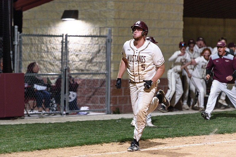 Eldon's Fischer Snelling scores the winning run in the bottom of the seventh inning against Fulton as the home dugout celebrates Tuesday at McMillen Field in Eldon.