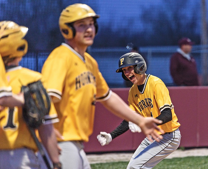 Fulton's Lincoln Smith celebrates after scoring on a game-tying grand slam hit by teammate James Walker in the top of the sixth inning of Tuesday's game against Eldon at McMillen Field in Eldon.