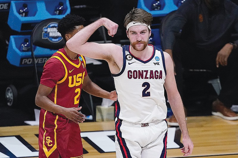 Drew Timme of Gonzaga celebrates in front of Southern California's Tahj Eaddy after making a basket during Tuesday night's Elite Eight game in the NCAA Tournament at Lucas Oil Stadium in Indianapolis.