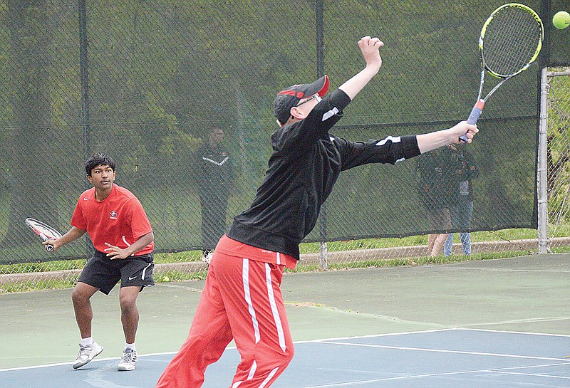 Jefferson City's Josh Wilde (foreground) reaches for a forehand shot during a 2019 doubles match against Hickman at Washington Park.