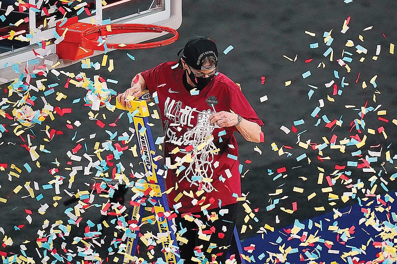 Stanford coach Tara VanDerveer cuts down the net Tuesday night as she and her team celebrate their win against Louisville in the Elite Eight round of the women's NCAA Tournament at the Alamodome in San Antonio.