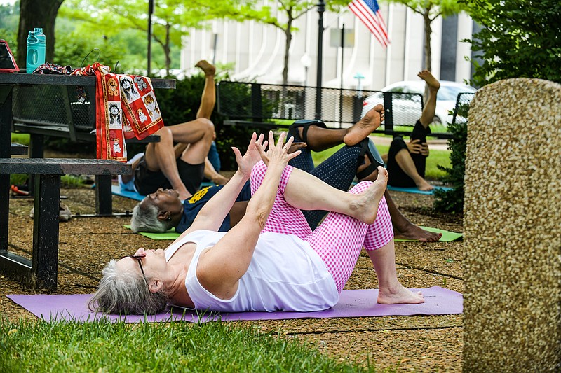 Julie Smith/News Tribune
Yoga in the Park has returned to Missouri River Regional Library with Thursday seeing about one-half dozen people return to or attend for the first time to the outside activity hosted by the library. This was the first time in several months they’ve gathered for yoga and the small group assured there was plenty of room for social distancing. Alberta Mobley. at left, taught the class and frequently added to her directions the phrase “if you are able” as she wasn’t sure how many of them maintained a yoga routine at home.