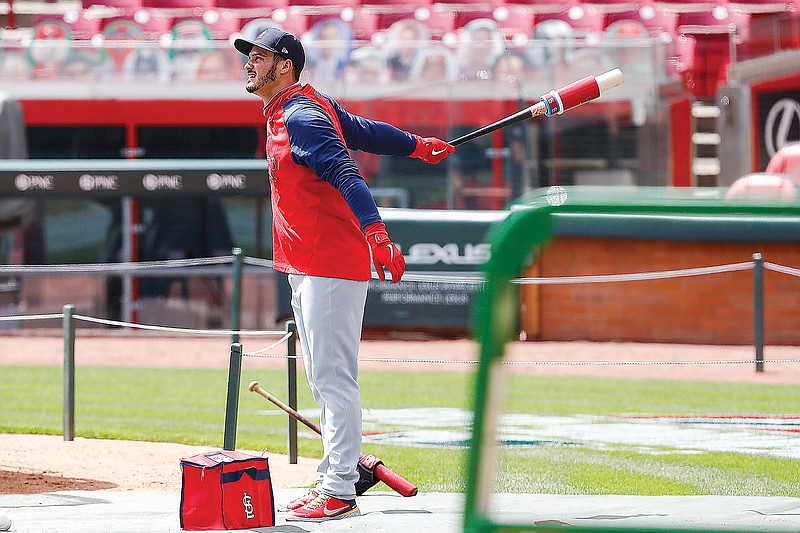 Nolan Arenado of the Cardinals waits to hit in the batting cage during a workout Wednesday in Cincinnati. The Cardinals will open the season today against the Reds.
