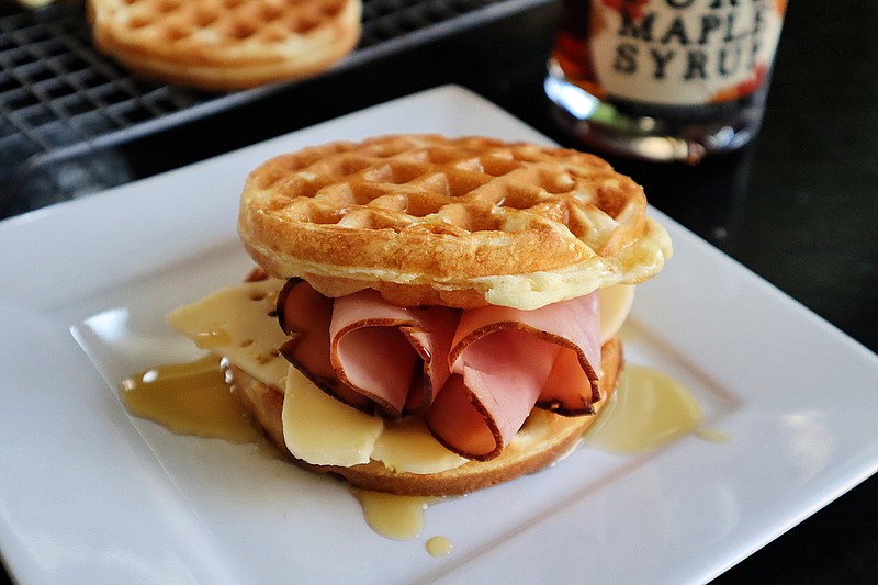 A drizzle of real maple syrup gives a ham and cheese waffle sandwich a sweet finish.(Gretchen McKay/Pittsburgh Post-Gazette/TNS)