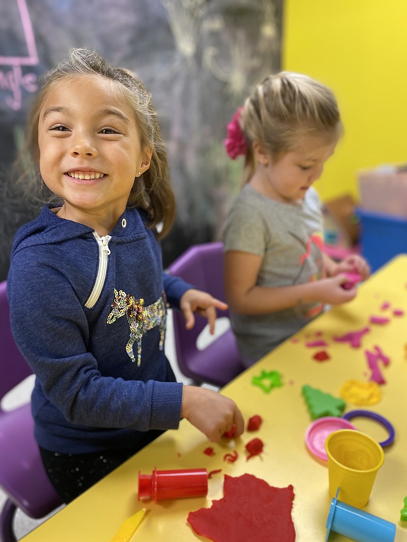 <p>Photo courtesy of Little Lighthouse</p><p>Little Lighthouse students cut shapes out of Play-Doh.</p>