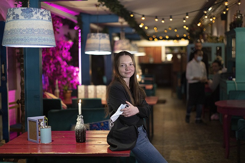 Valentina Konstantinova, co-founder of the Skazka, or "Fairytale," a boutique hotel in eastern Moscow, stands during her interview with The Associated Press on Tuesday, March 23, 2021. When Russia locked down for the coronavirus a year ago, her 18-room emptied out within a couple of days. A year later, Skazka is still open — thanks to some creative thinking by Konstantinova, who makes up some revenue by having added a restaurant that serves Indian cuisine. (AP Photo/Alexander Zemlianichenko)