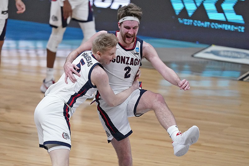 Gonzaga teammates Martynas Arlauskas (5) and Drew Timme celebrate after Tuesday night's win against Southern California in the NCAA Tournament at Lucas Oil Stadium in Indianapolis.