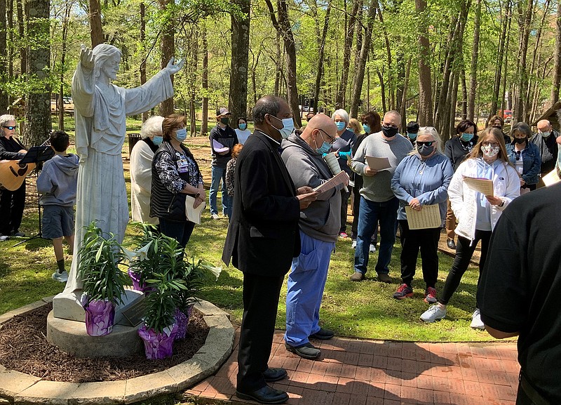 The Rev. Lawrence X. Chellaian, center, CHRISTUS St. Michael Health System's vice president of mission integration, leads a Stations of the Cross service Friday at Sisters' Park on the hospital's campus in Texarkana. (Submitted photo)
