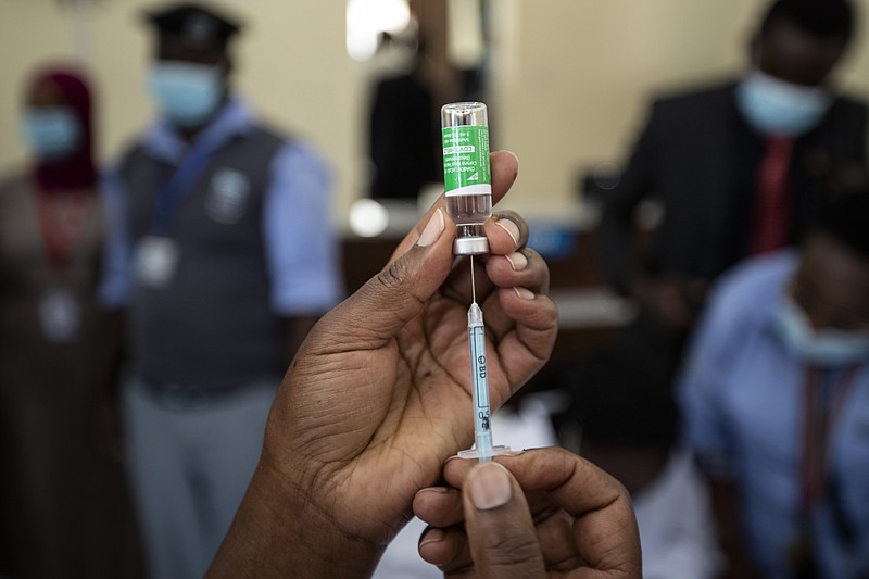 FILE—In this Friday, March 5, 2021 file photo, a nurse prepares to administer a dose of the AstraZeneca COVID-19 vaccine manufactured by the Serum Institute of India and provided through the global COVAX initiative, at Kenyatta National Hospital in Nairobi, Kenya. Kenya has ordered an immediate suspension on private importations of vaccines, citing fears that it  may lead to counterfeit inoculations getting into the country. The National Emergency Response Committee said the move is meant to ensure transparency and accountability in the process of vaccinations. (AP Photo/Ben Curtis, FIle)