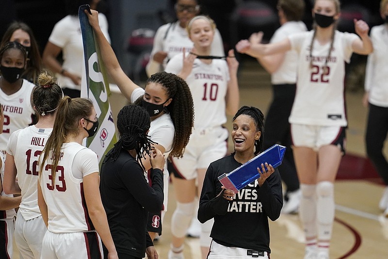 In this Feb. 22 file photo, Stanford guard Kiana Williams (right) celebrates with teammates after a win against Arizona in Stanford, Calif.