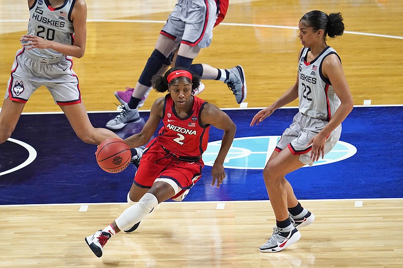 Aari McDonald of Arizona drives around Connecticut's Evina Westbrook during Friday night's semifinal game in the NCAA Tournament at the Alamodome in San Antonio.