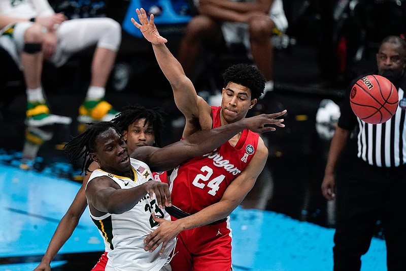 Baylor forward Jonathan Tchamwa Tchatchoua (23) passes around Houston guard Quentin Grimes (24) during the second half of a men's Final Four NCAA college basketball tournament semifinal game, Saturday, April 3, 2021, at Lucas Oil Stadium in Indianapolis. (AP Photo/Michael Conroy)