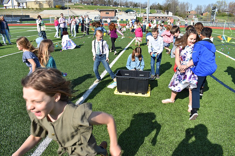 Gerry Tritz/News Tribune
Children scramble to collect plastic eggs filled with candy at the start of Capital City Christian Church's Easter Egg hunt Easter morning at Ray Hentges Stadium.