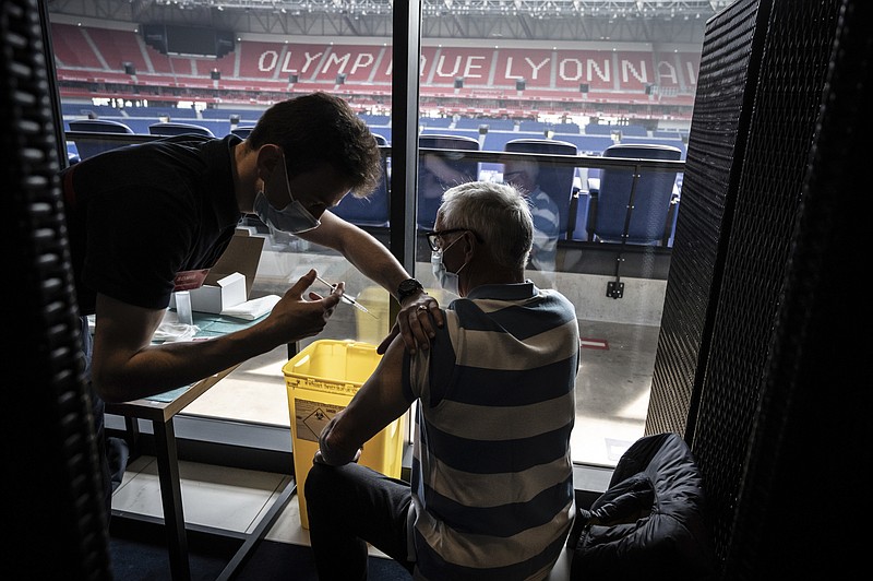 Patients receive an injection of the Moderna Covid-19 vaccine on the opening day of a mass vaccination centre set up in the Olympique Lyonnais soccer Stadium, in Decines-Charpieu, Saturday, April 3, 2021. (Jean-Philippe Ksiazek, Pool via AP)