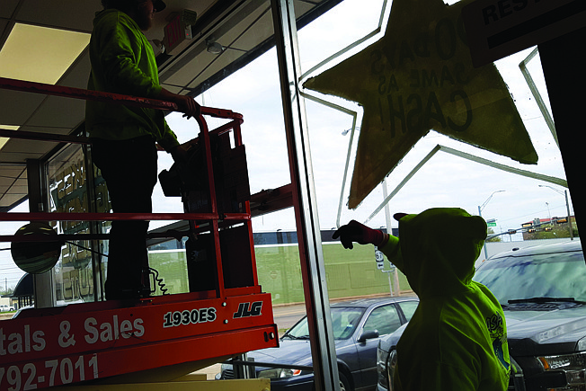 Paul Dornberg, right, of Nash Electric Co., works with a fellow technician to update wiring at the former Golden Star Tire. The building is being prepared for the incoming Winston Water Cooler Plumbing Supply Store. 