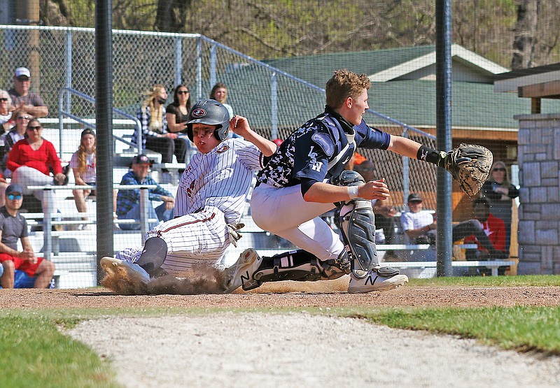 Jefferson City's Taylor Hopkins slides into home plate to score a run during Saturday afternoon's game against Lee's Summit West at Vivion Field.