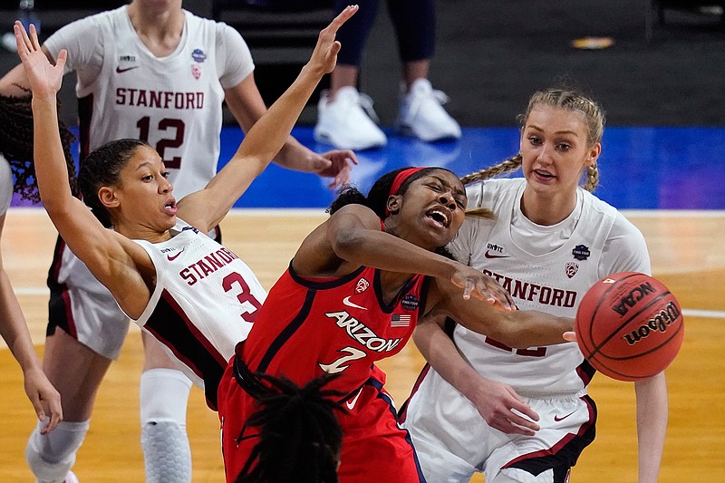 Arizona guard Aari McDonald (2) passes between Stanford guard Anna Wilson (3) and forward Cameron Brink, right, during the second half of the championship game in the women's Final Four NCAA college basketball tournament, Sunday, April 4, 2021, at the Alamodome in San Antonio. (AP Photo/Eric Gay)