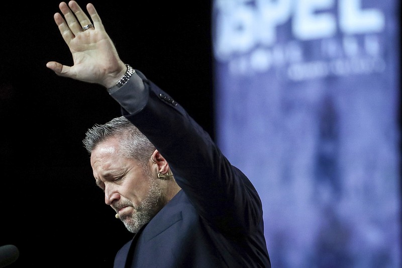 FILE - In this Wednesday, June 12, 2019 file photo, J. D. Greear, president of the Southern Baptist Convention, talks about sexual abuse within the SBC on the second day of the SBC's annual meeting in Birmingham, Ala. On March 30, 2021, Greear posted a photo on Facebook of him getting the COVID-19 vaccine. It drew more than 1,100 comments — many of them voicing admiration, and many others assailing him. (Jon Shapley/Houston Chronicle via AP)