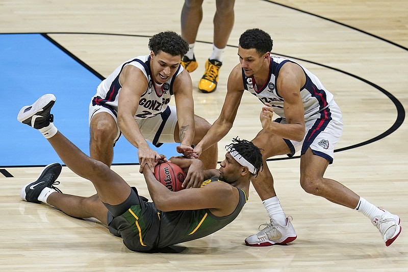 Baylor forward Flo Thamba fights for a loose ball with Gonzaga forward Anton Watson (left) and guard Jalen Suggs during Monday night's NCAA Tournament title game at Lucas Oil Stadium in Indianapolis.