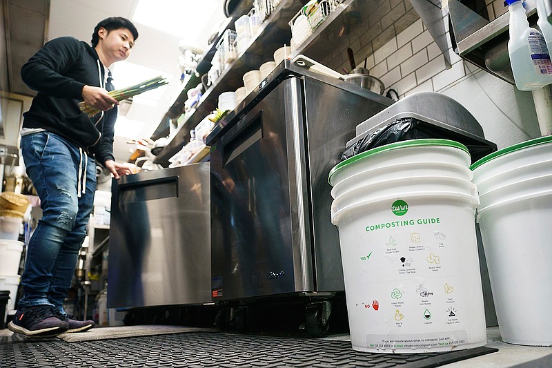 Tex Sirisawat does prep work in the kitchen at Khao Noodle Shop near Turn Compost bins on Monday, Nov. 25, 2019, in Dallas. Turn Compost is a DFW-startup offering a service to pick up buckets compostable items that would otherwise end up in a landfill. (Smiley N. Pool/The Dallas Morning News/TNS)