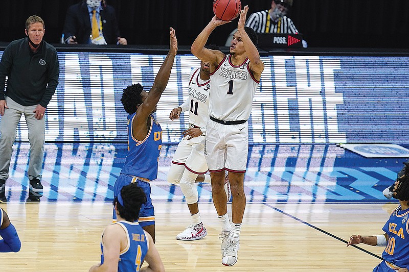 Jalen Suggs of Gonzaga shoots over David Singleton of UCLA to hit the game-winner at the end of overtime in Saturday night's NCAA Tournament semifinal game at Lucas Oil Stadium in Indianapolis.