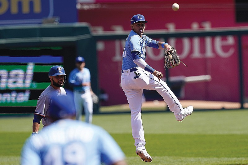 A throw from the outfield goes over the head of Royals shortstop Nicky Lopez during the first inning of Sunday afternoon's game against the Rangers at Kauffman Stadium.