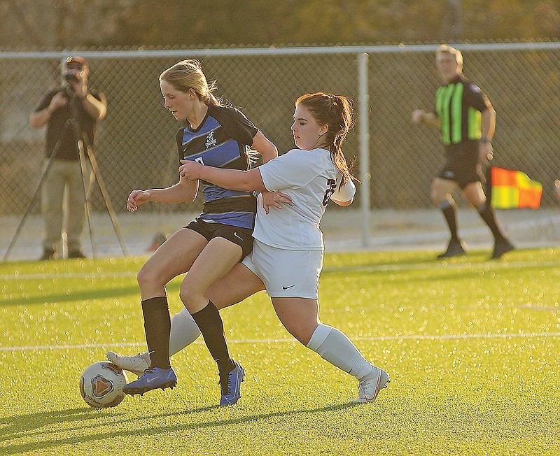 Livy Sloan of Capital City and Maya Saint of Jefferson City battle for control of the ball during Monday's game at Capital City High School.