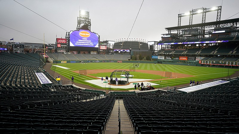 Players take part in batting practice as a light rain descends on Coors Field Tuesday, April 6, 2021, before the Colorado Rockies host the Arizona Diamondbacks in a baseball game in Denver. Major League Baseball announced that Coors Field will be the venue for the 2021 All-Star Game after the Midsummer Classic was moved out of Atlanta because of sweeping changes to voting rights established in the state of Georgia. (AP Photo/David Zalubowski)