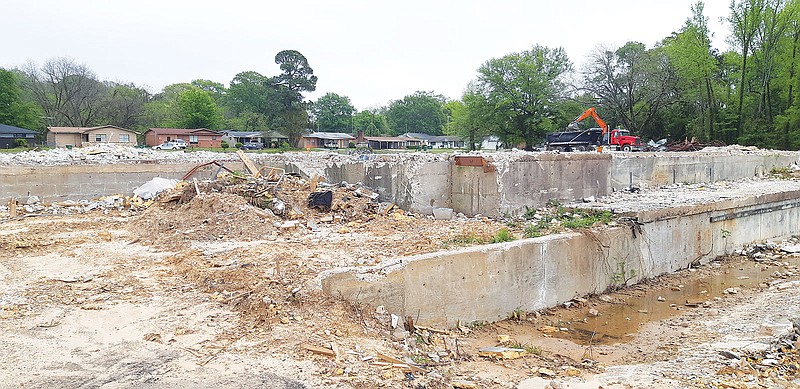 Earth movers of Stan Excavating Company remove the remaining debris of the former Texarkana College annex, leaving the foundation. Eventually, the area will be converted to green space, according to a company representative. After that, it will be returned to the college.