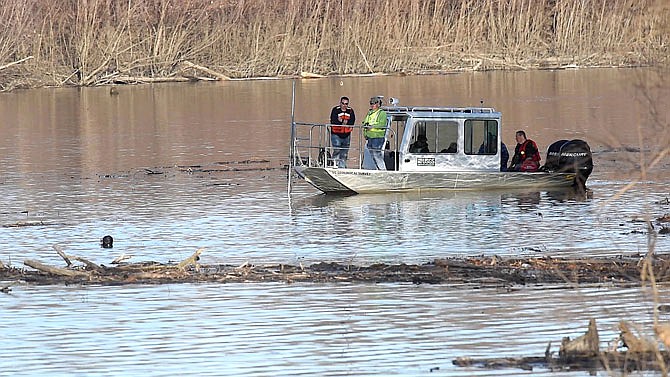 FILE: Missouri law enforcement personnel aided by the United States Geological Survey team use imaging sonar in December to try to locate the body of Mengqi Ji Elledge near Columbia. Divers searched for Elledge in the Lamine River in Cooper County.
