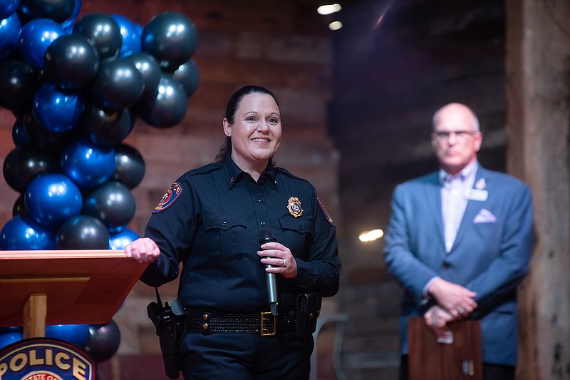 Kristi Bennett addresses the crowd Wednesday following her pinning ceremony as the first female chief of the Texarkana Arkansas Police Department as Mayor Allen Brown stands behind her at Crossties.