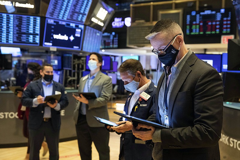 In this photo provided by the New York Stock Exchange, traders work on the floor Wednesday, April 7, 2021. Stocks wobbled between small gains and losses in afternoon trading on Wall Street Wednesday, hovering around their record highs as investors remain cautiously optimistic about the economic recovery. (Colin Ziemer/New York Stock Exchange via AP)