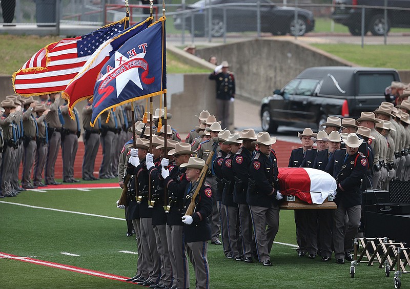 Texas Department of Safety trooper honor guards carry the casket of DPS Trooper Chad Walker for his funeral Wednesday April 7, 2021, in Groesbeck, Texas. Trooper walker was killed in the line of duty last week. (Jerry Larson/Waco Tribune-Herald via AP)