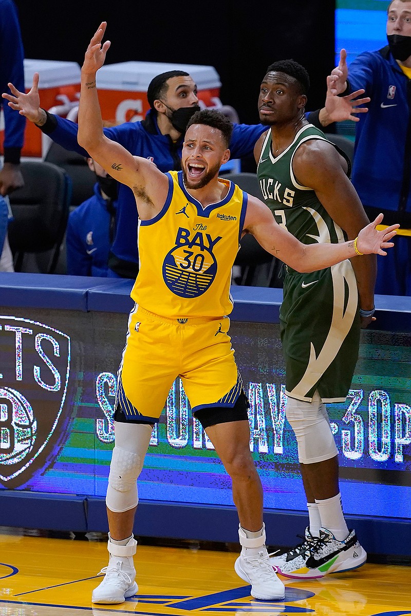 Golden State Warriors guard Stephen Curry (30) reacts after being fouled by Milwaukee Bucks forward Thanasis Antetokounmpo, rear, during the second half of an NBA basketball game in San Francisco, Tuesday, April 6, 2021. (AP Photo/Jeff Chiu)