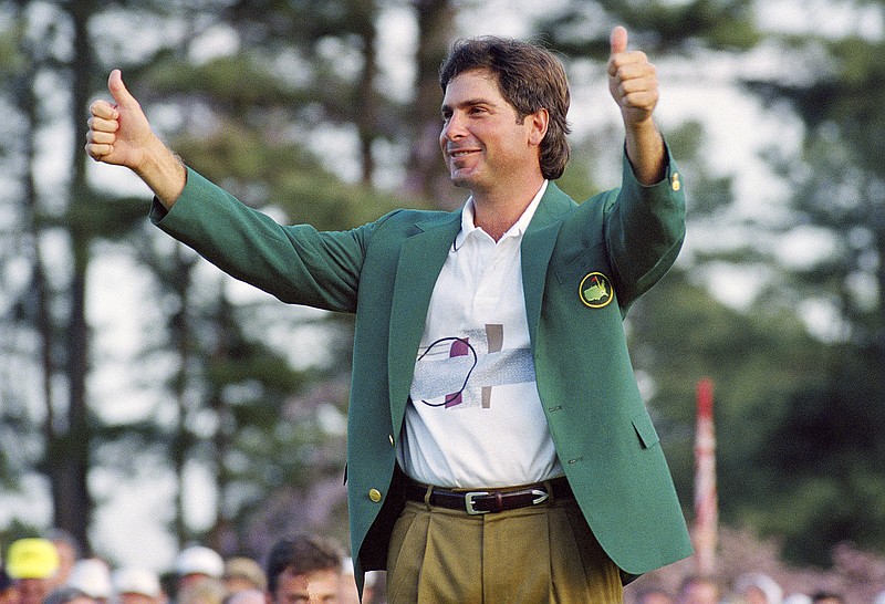 In this April 12, 1992, file photo, Fred Couples gives the thumbs-up after getting the traditional green jacket after winning the Masters at the Augusta National Golf Club in Augusta, Ga.