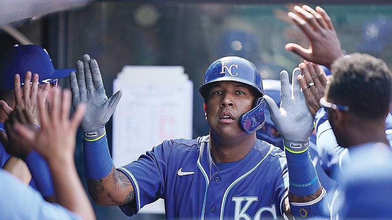 Salvador Perez is congratulated by his Royals teammates after hitting a solo home run in the fourth inning of Wednesday afternoon's game against the Indians in Cleveland.