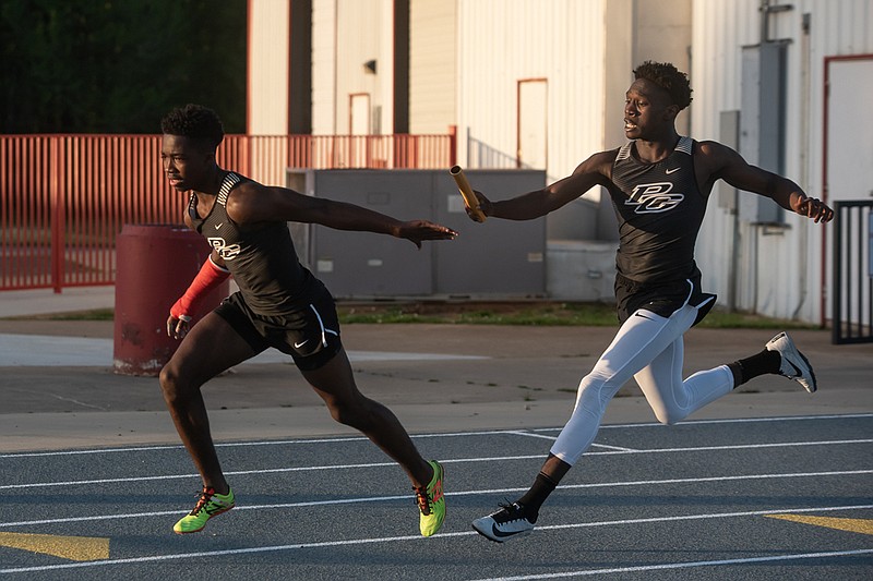 Pleasant Grove runners pass off a baton during the boys 400-meter relay Thursday evening at the varsity district meet hosted by Liberty-Eylau High School in Texarkana.