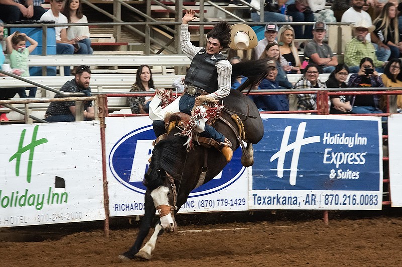 Kaul Runfola rides a bucking horse for the saddle bronc riding portion of the Four States Rodeo on Friday night. Runfola finished with a score of 67.
