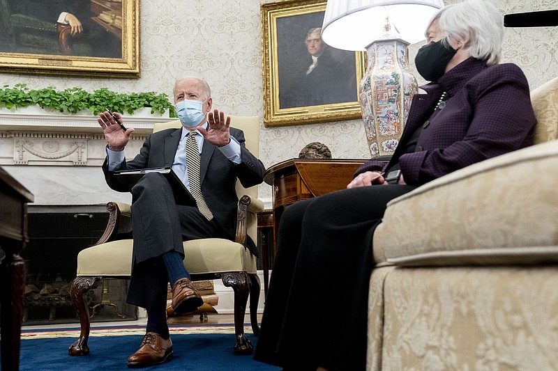 President Joe Biden, accompanied by Treasury Secretary Janet Yellen, right, speaks as he gets his weekly economic briefing in the Oval Office of the White House, Friday, April 9, 2021, in Washington. (AP Photo/Andrew Harnik)